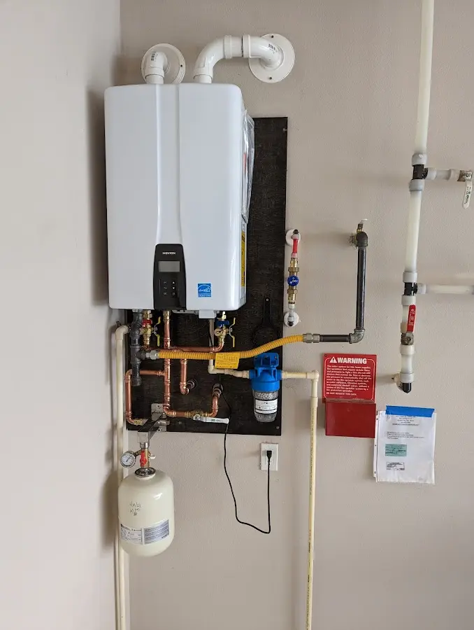 Professional plumber installing copper piping in a Clinton home